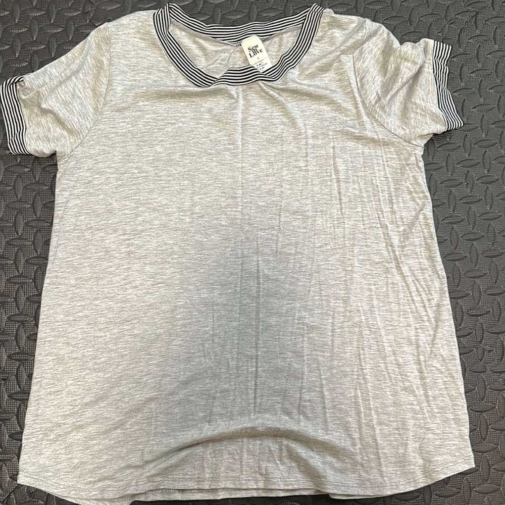 Brand new without tags soft tee. Has some striping on sleeves and neckline. Soft